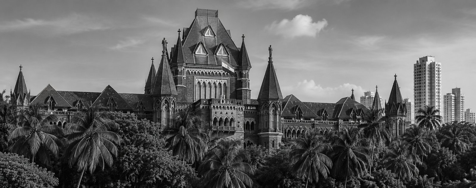 The Bombay High Court building framed by palm trees